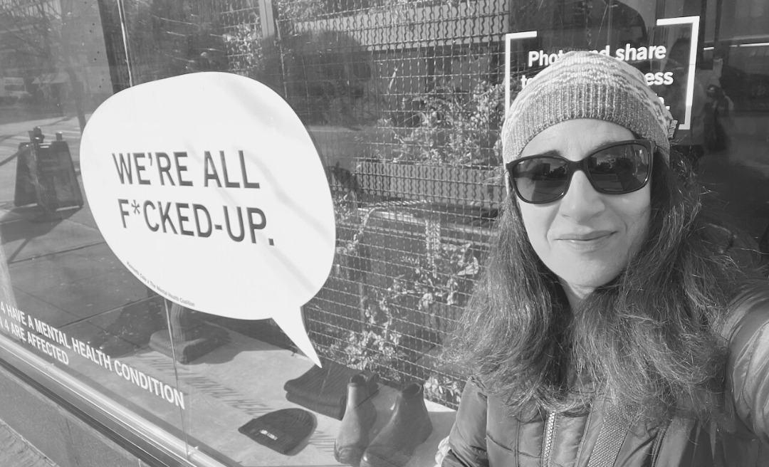 midlife got me crazy midlife friendships midlife mayhem when life is crazy, we need friends; maryann standing in front of a store sign that says "We are all f-- up"